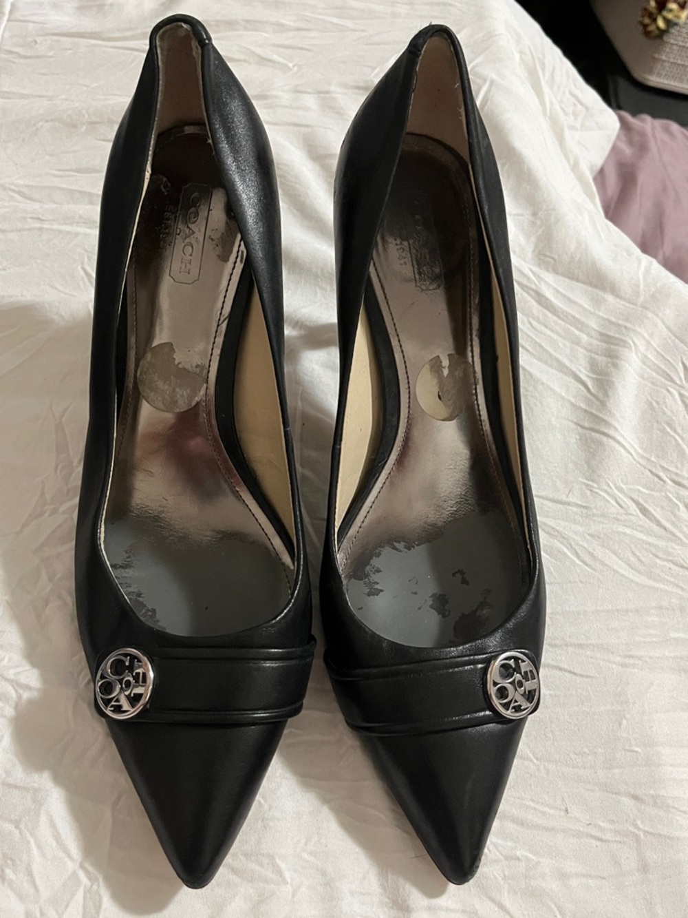 Coach Black Pointed Toe Heels with Silver Logo Medallion